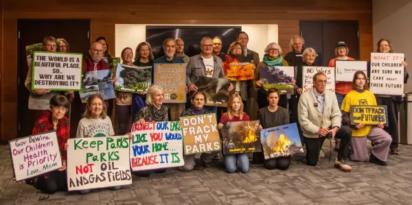 People posing with signs