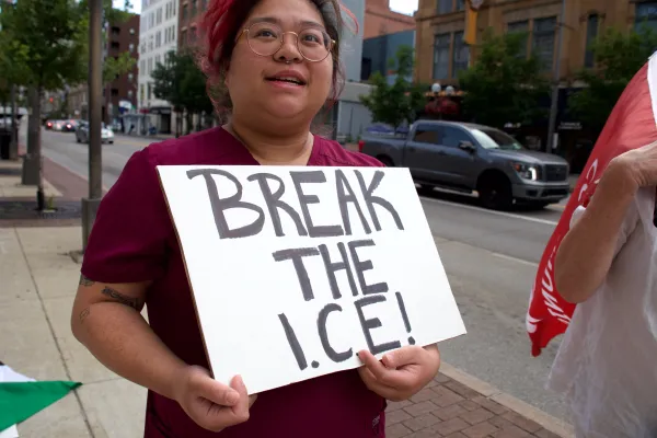 Woman with sign saying Break the ICE