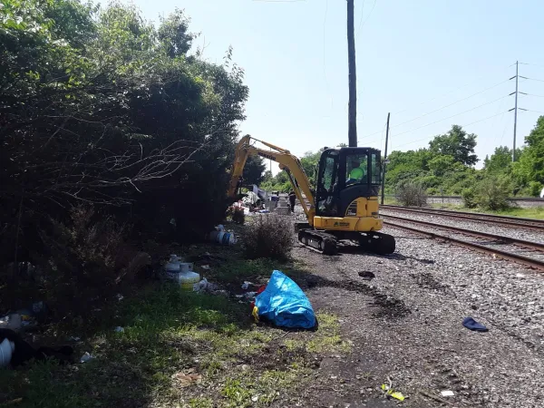 Bulldozer taking down a houseless encampment