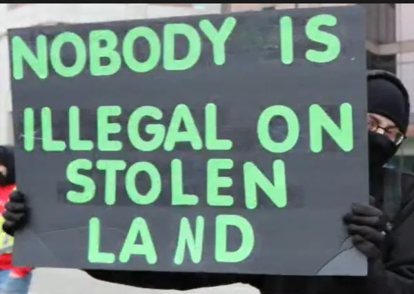 Sign saying nobody is illegal on stolen land
