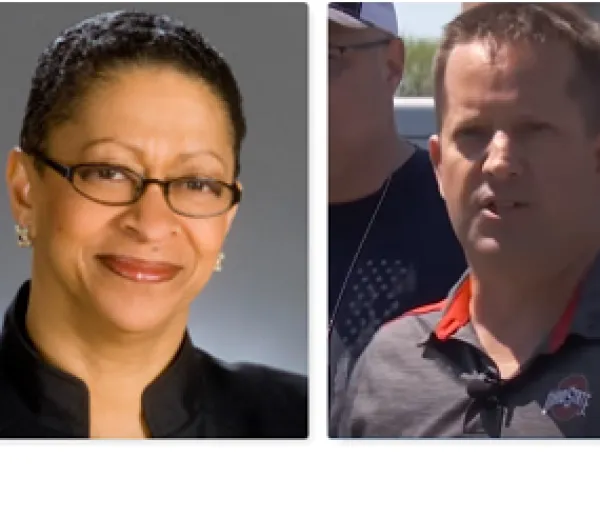 Black woman smiling and white man talking