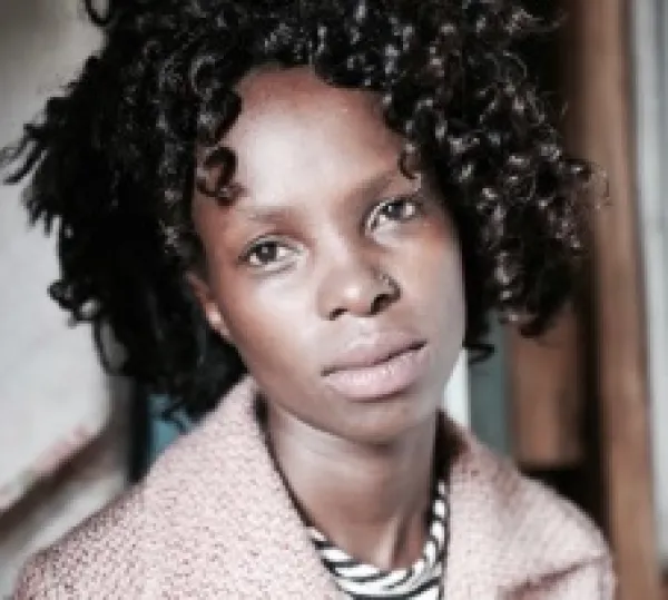 Young black woman with short ringlets and with a kind of sad expression