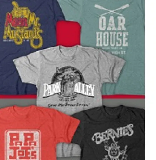 Five T-shirts laying out flat each with a different logo from a campus bar on it