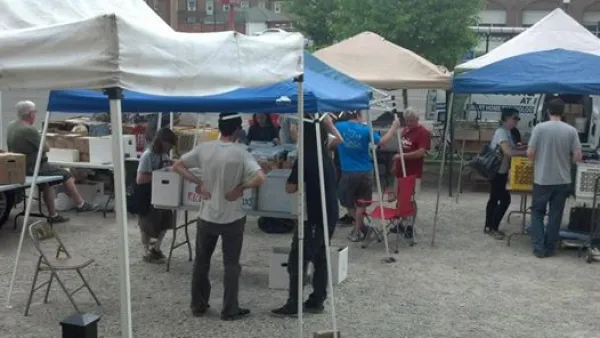 People under outdoor booth tents looking at records