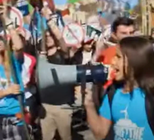 People marching, girl shouting into megaphone