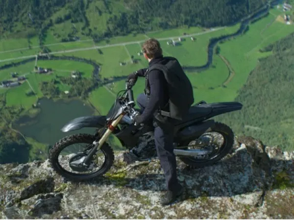Man on a motorcycle on a cliff