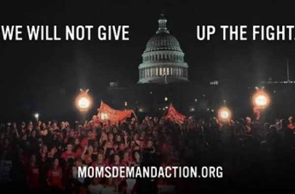 Big government building rotunda in the dark and people rallying in front