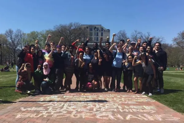 Students with fists in air on Oval