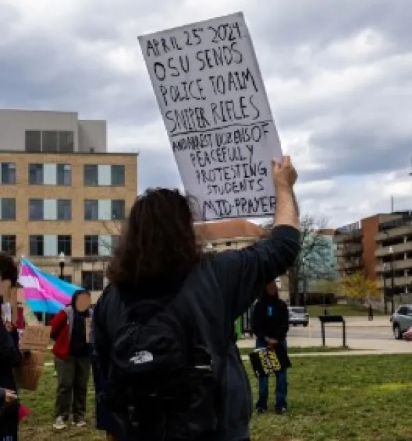 Young woman holding sign