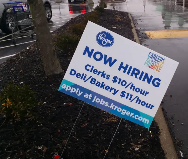 Yard sign saying Kroger is hiring people at $10 and $11 dollars an hour