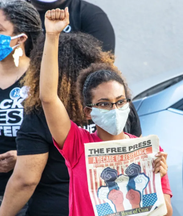 Women at protest holding Free Press