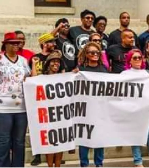 People outside holding banner