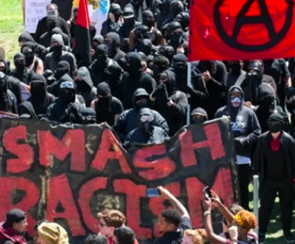 People outside with Smash Racism sign