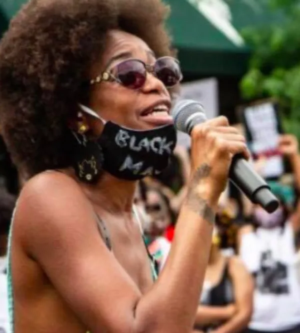 Black woman speaking into a mic