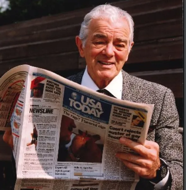 Older man reading the USA Today