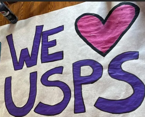 Sign saying We Love USPS