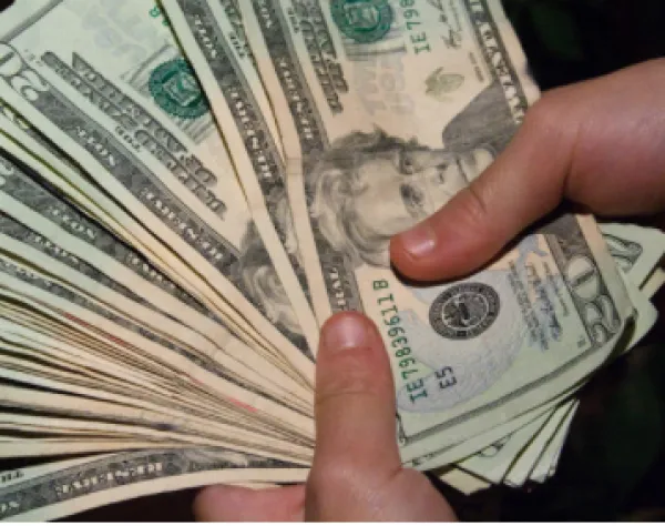 20 dollar bills in someone's hands