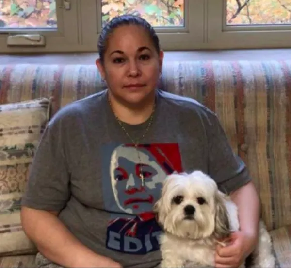 Latina woman and dog sitting on couc