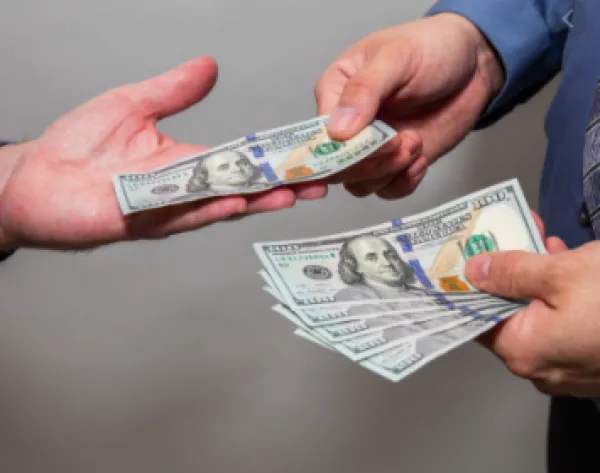 Someone handing someone else money