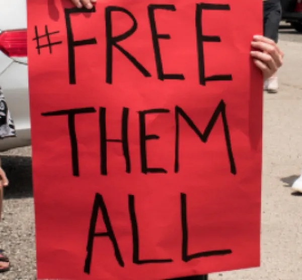 Sign saying Free Them All