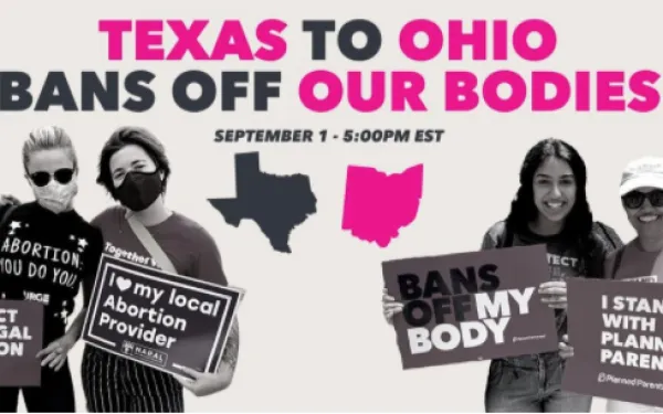 People holding signs with details of event