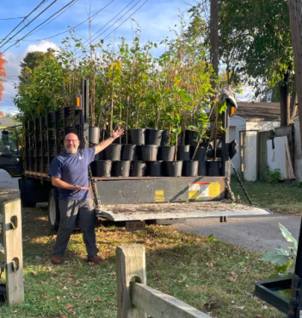 Man posing in front of trees