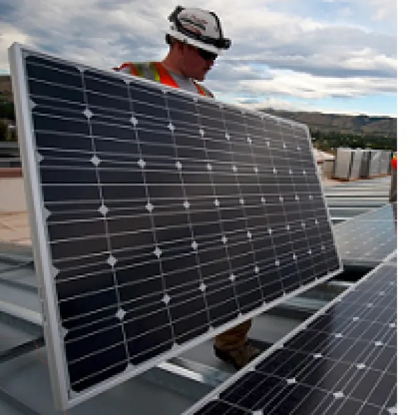 Men installing solar panels on a roof