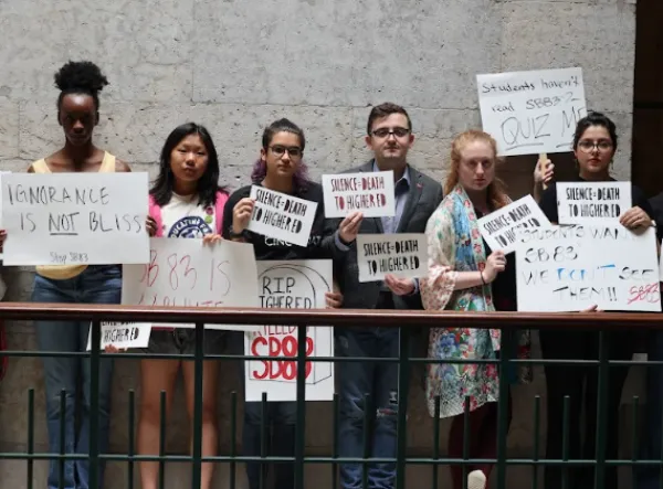 Students holding signs