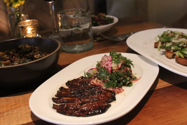 Brussels sprouts (front left), grilled Portobello mushroom (front center), toast (front right), kale and roasted vegetables (rear center)  