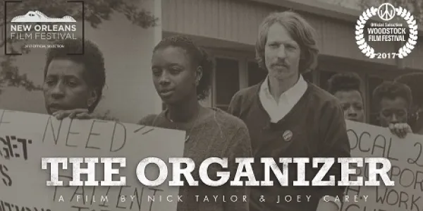 Black and white photo of a man with long hair and a moustache and the word ORGANIZER