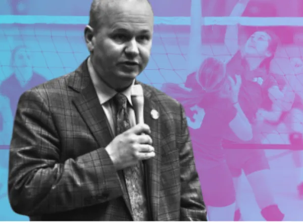 Bald white man talking into a mic