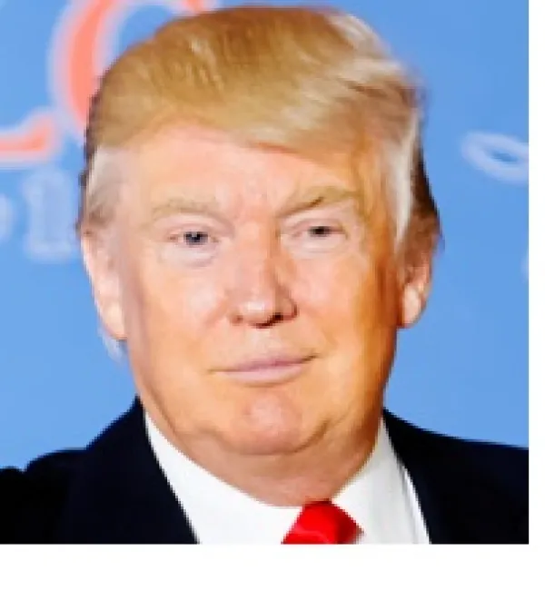 Old white man with orange hair coming down on his forehead looking goofy