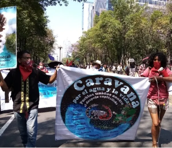 People marching holding sign