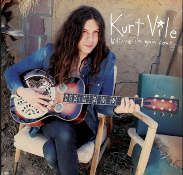 Guy with long hair playing guitar