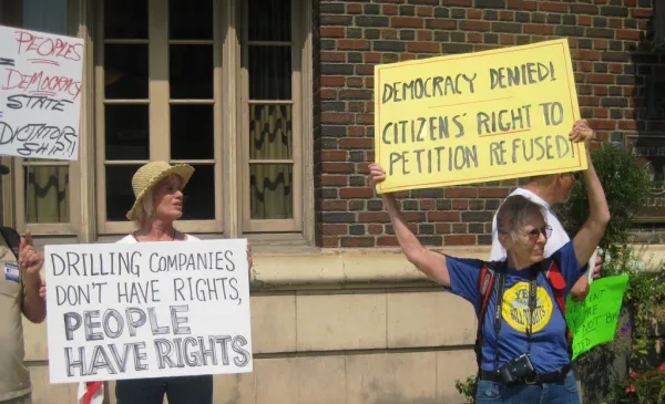 Two women holding protest signs