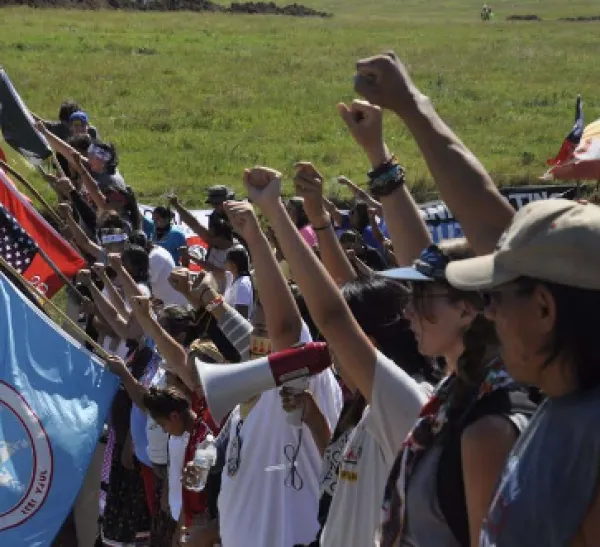 People standing with fists in air