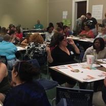 Lots of diverse people sitting at tables in a big room