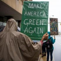 Person hold Make American Green Again sign