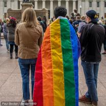 Protesters at the Ohio Statehouse one with a rainbow flag