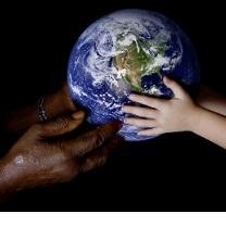 Black hands at left and white hands at right both holding an Earth globe in the middle