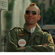 Robert De Niro, youngish white man with a mohawk hairsut and sunglasses smiling with his arms crossed, wearing an army jacket with patches
