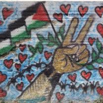 Peace sign and Palestinian flag surrounded by hearts