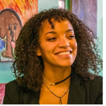 Young black woman smiling with curly shoulder length hair
