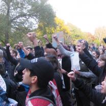 People with their fists in the air at an anti-Trump rally