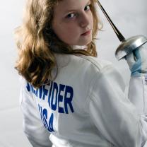 Very young blonde girl looking tough holding a sword