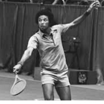 Black and white photo of young black man with afro playing tennis
