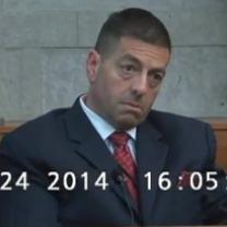 White middle aged man with crew cut and big bags under his eyes wearing a suit looking off to the side with a very worried expression on his face 