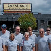 People standing in front of billboard