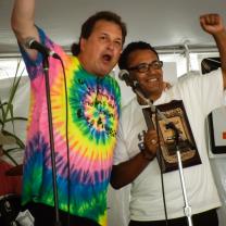 Two men on stage holding their fists in the air