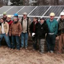 People involved in Clintonville Energy Co-op posing by solar panels